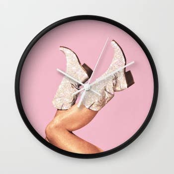 a pink clock with a set of sparkly cowboy boots as the clockface