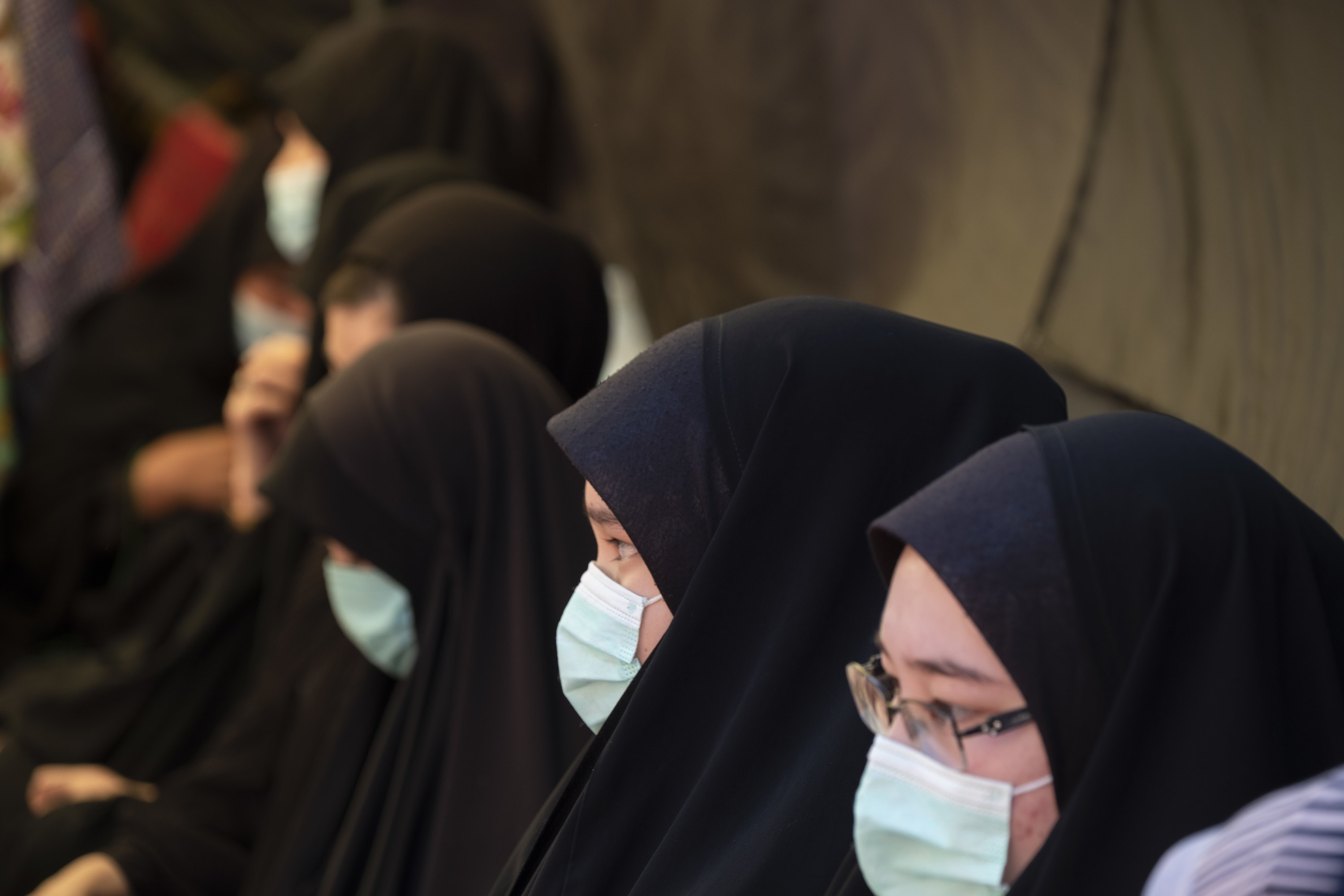 Women wearing hijab and surgical masks