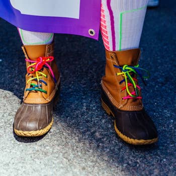 model wearing LL Bean's Bean Boots with rainbow laces