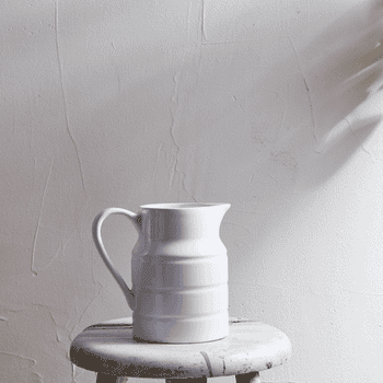 a gif of a vase being filled with different colored felt flowers
