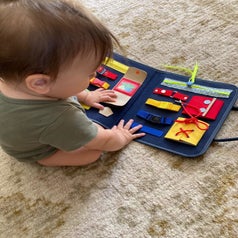 Reviewer's child playing with the busy board