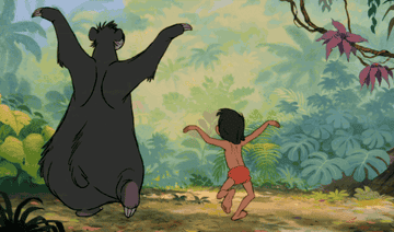 a gif of baloo and mowgli from the jungle book dancing and clapping