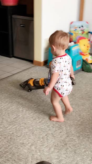 Reviewer's child using the vacuum