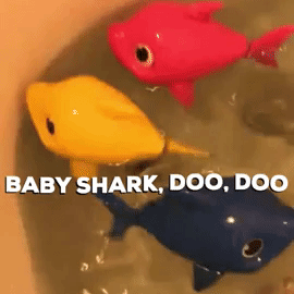 Reviewer's gif showing the pink, yellow and blue baby shark toys swimming in the bathtub