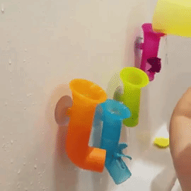 Reviewer's gif showing their child pouring water in the pipes at bath time