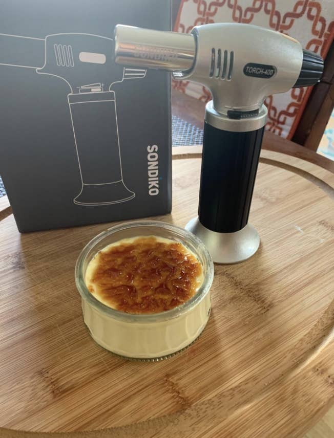 a reviewer&#x27;s photo of the blow torch and a creme brule