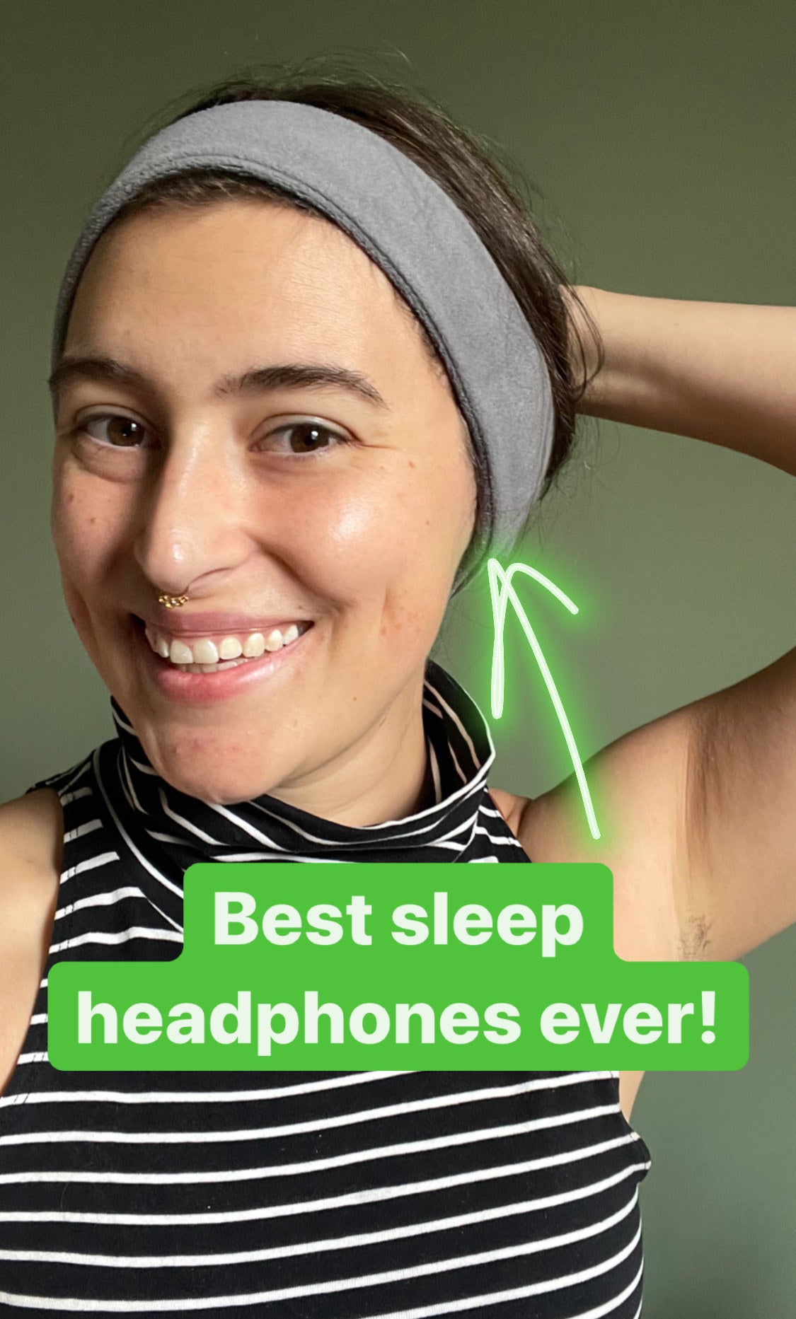 the writer smiling and wearing the fleece headphones captioned &quot;best sleep headphones ever&quot;