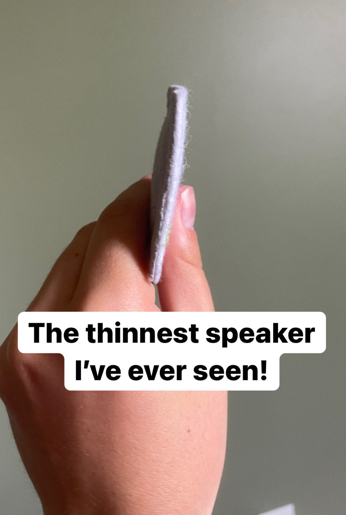 the writer showing the super thin speaker from the side captioned "the thinnest speaker I've ever seen"