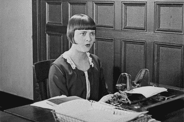 A scene of a secretary typing angrily
