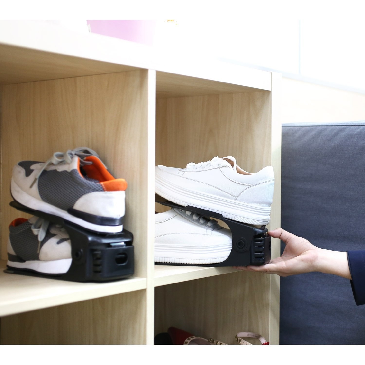 The shoe slots are designed to place one shoe on top of the other. Two pairs of shoes are neatly stored in a cubbyholes.