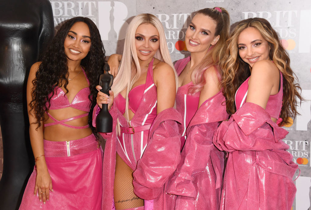 Little Mix at the Brit Awards in matching outfits with Jesy holding their trophy