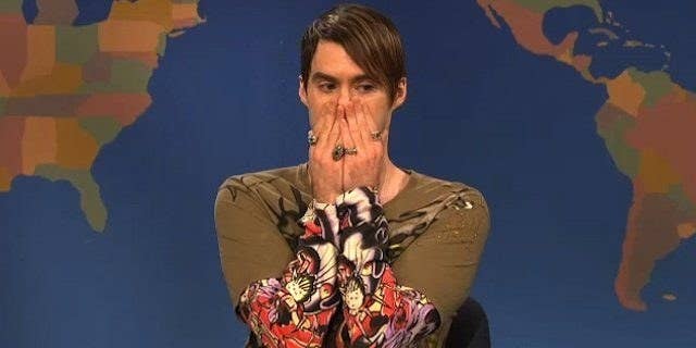 Stefan from Saturday Night Live covers his mouth with his hands as he thinks