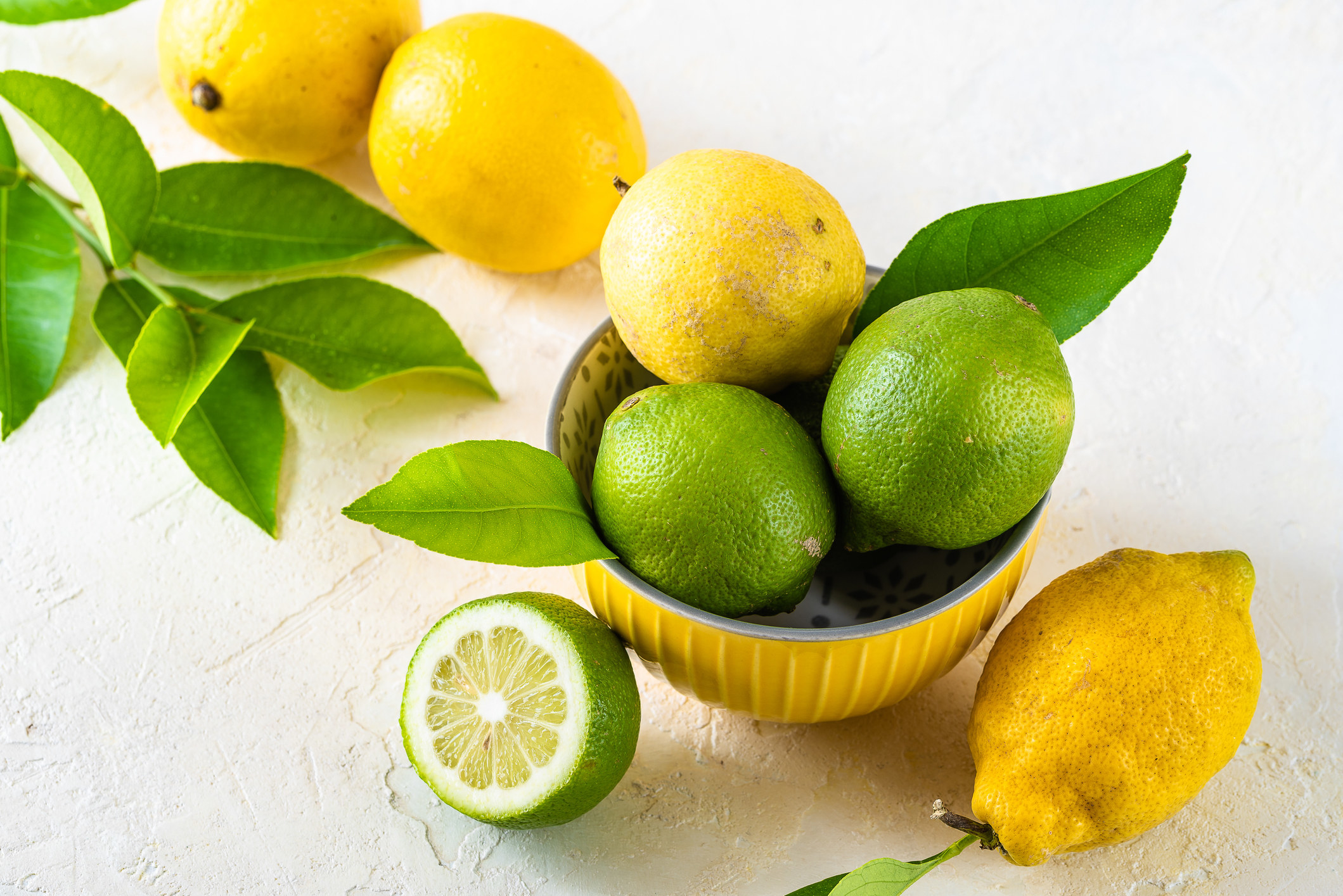 a bowl of lemons and limes