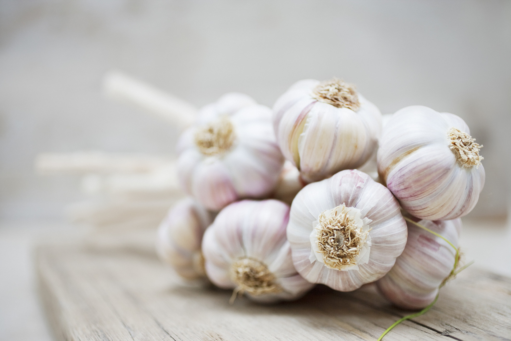 a pile of garlic on a cutting board