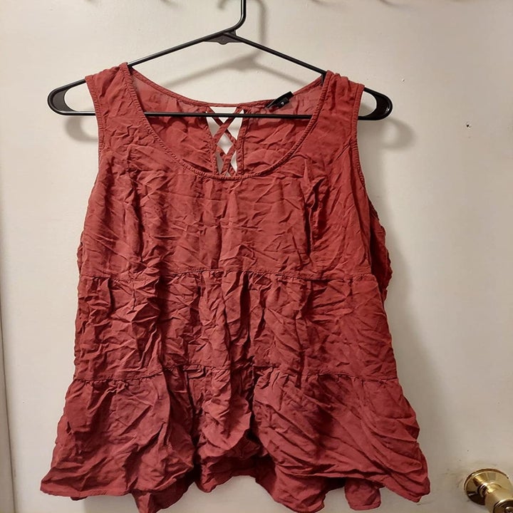 Reviewer photo of an extremely wrinkled red tank top