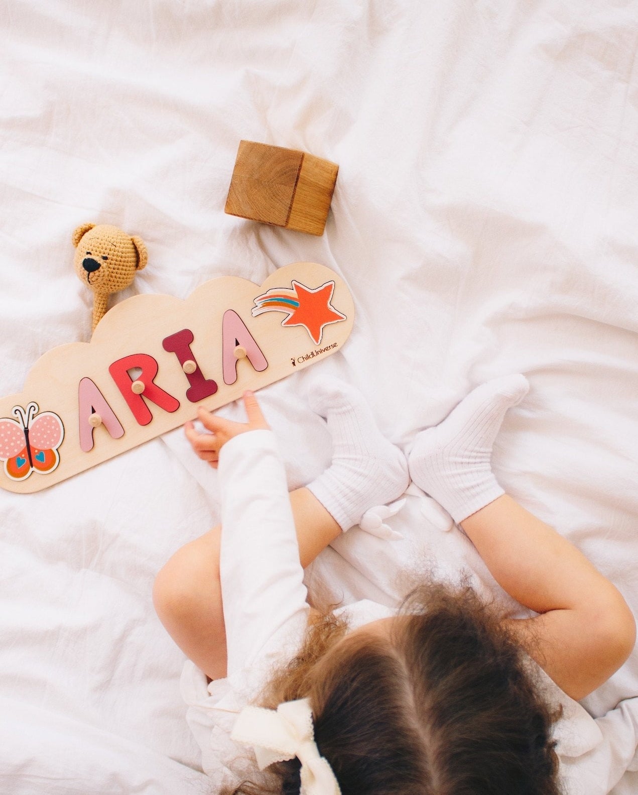 A child playing with the wooden name puzzle
