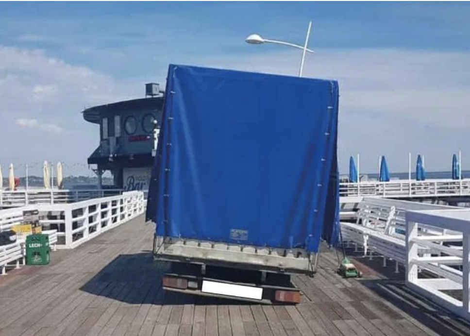 The back of a lopsided truck stuck on a pier