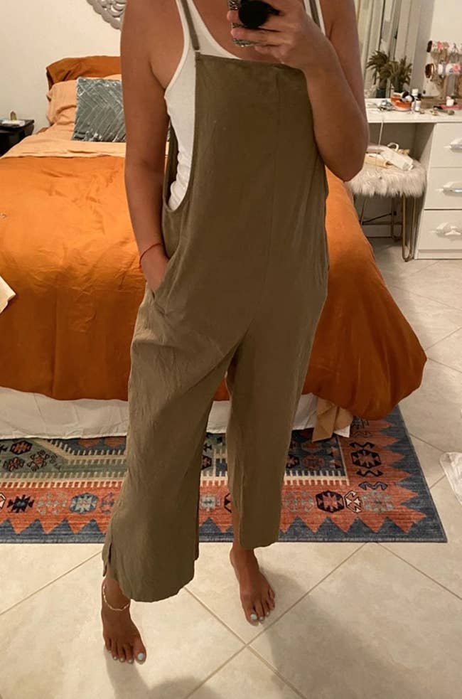 the overall jumpsuit on a reviewer in camel