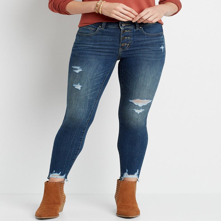 model in distressed blue jeans