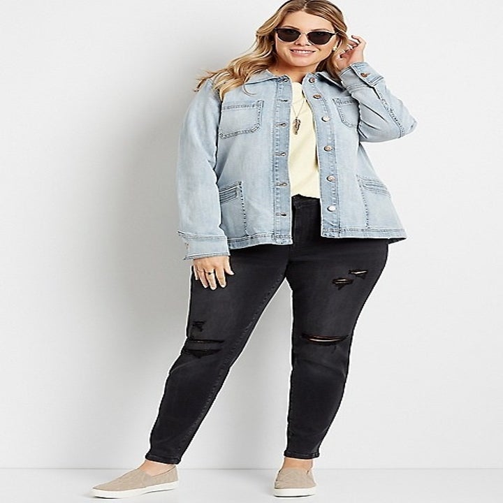 model in black distressed jeans