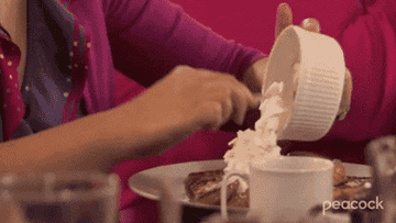 Leslie Knope putting whipped cream on waffles