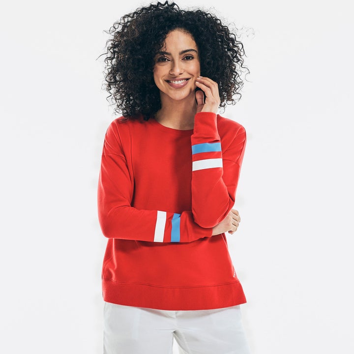 model in a red sweatshirt with sleeve stripes