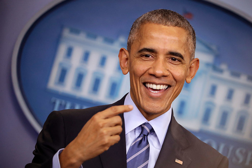 Obama smiles as he addresses the press