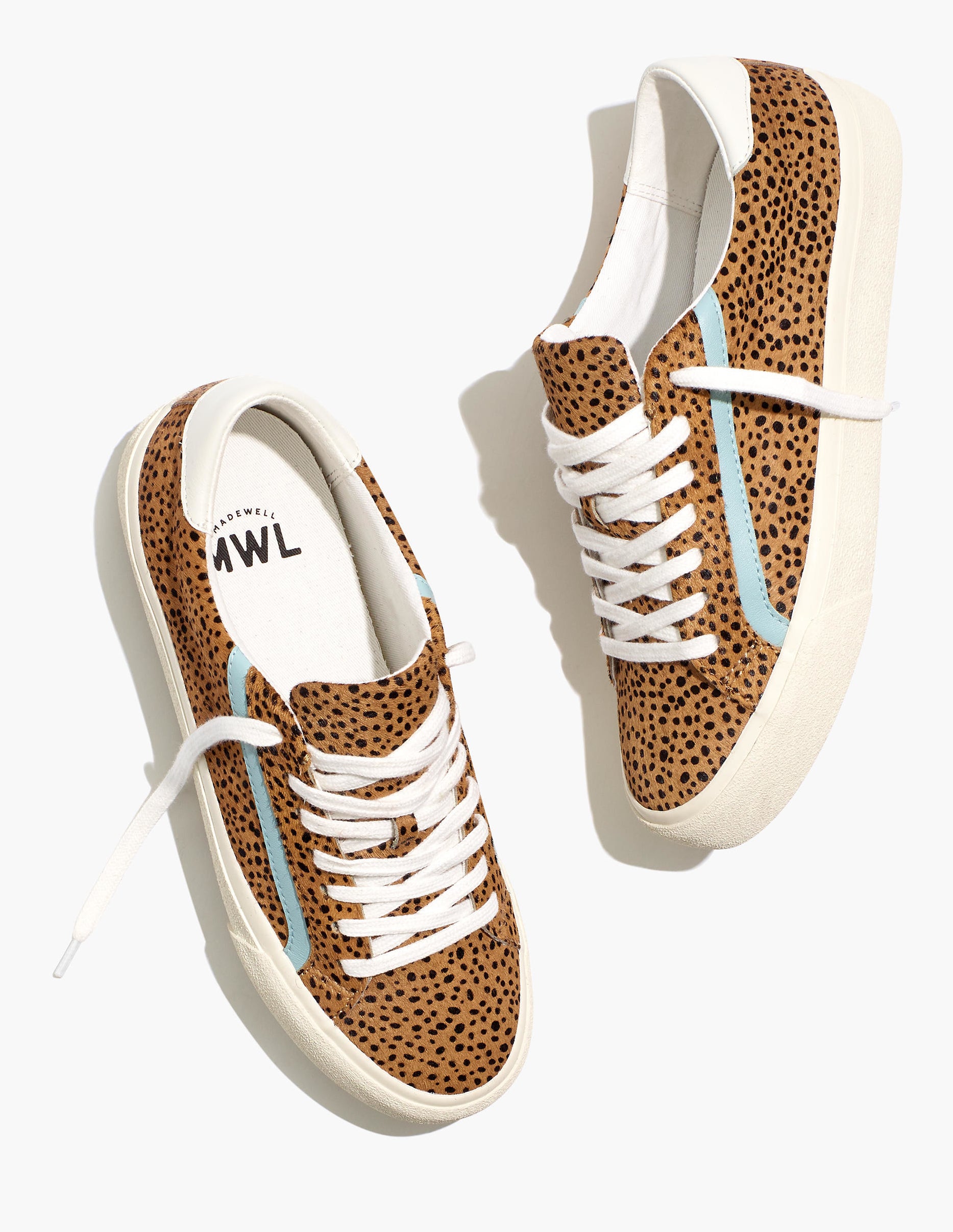 the tan calf hair spotted sneakers with a solid pale blue line on the side of each shoe