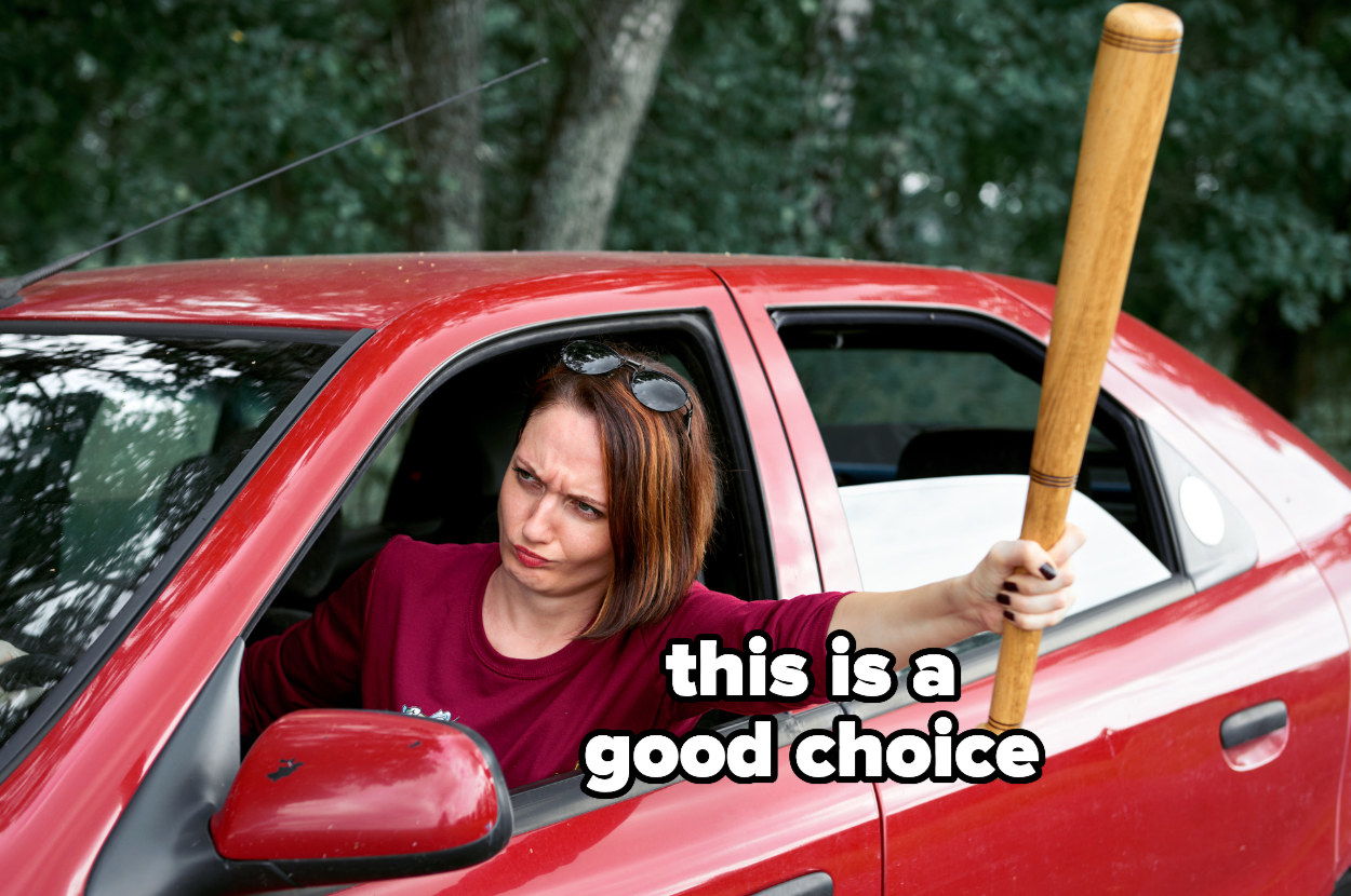 woman driving with one hand out the window holding a baseball bat