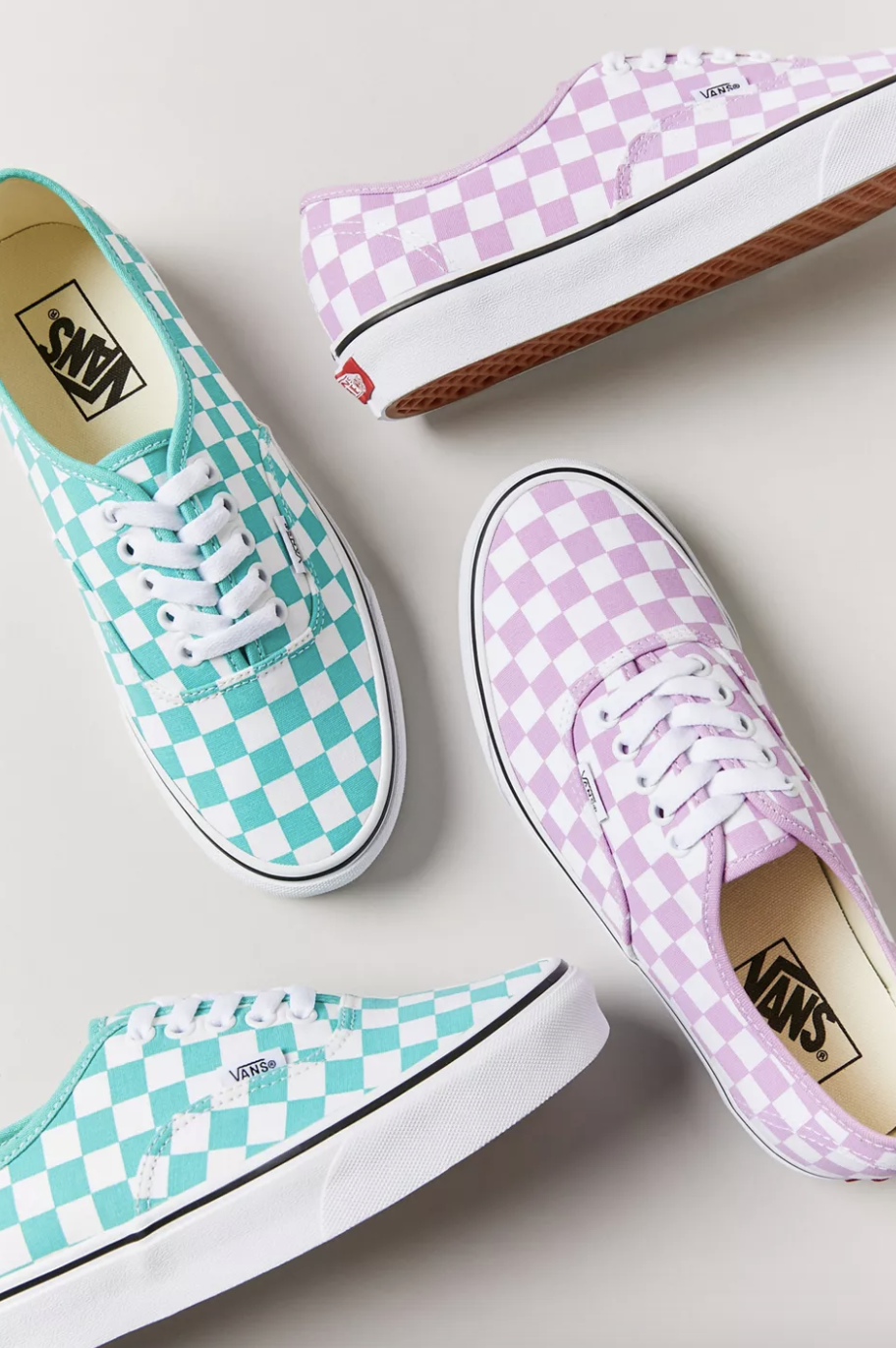a pair of teal checkerboard lace up sneakers and the same shoes in lavender