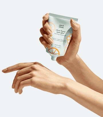 A gif of a model squeezing the moisturizer out of the bottle and onto their hand