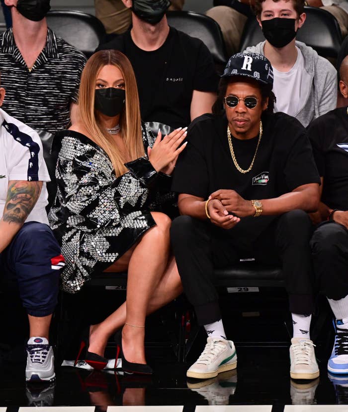 Beyoncé and Jay-Z sitting front row at a basketball game