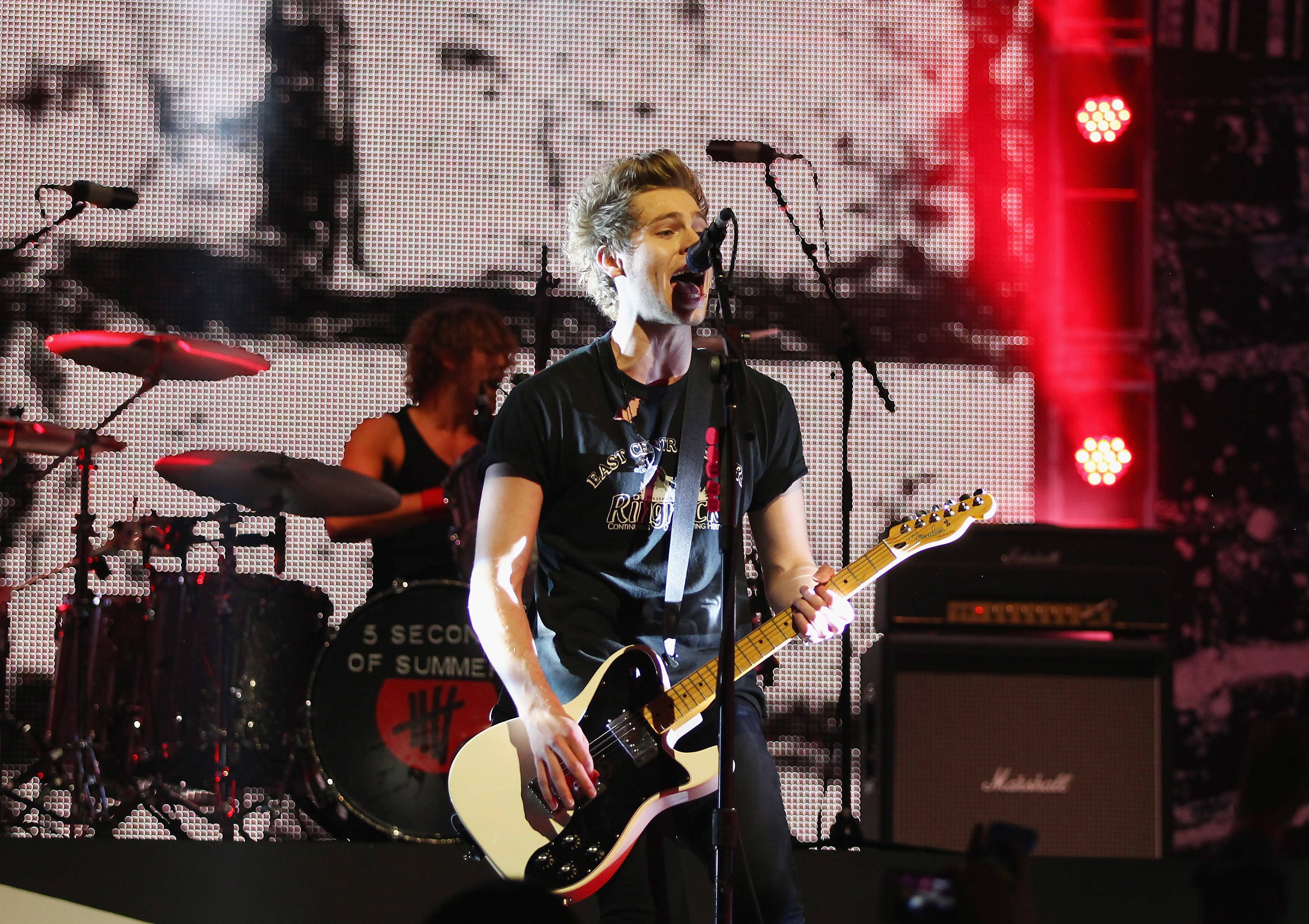 Luke playing guitar and singing onstage