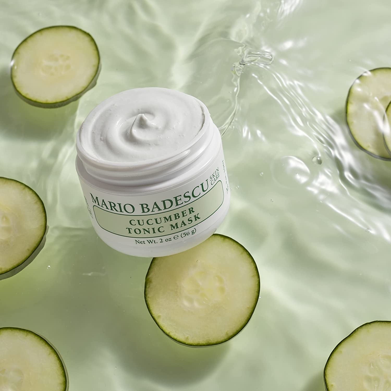 A jar of the cucumber mask against a backdrop of water and cucumber slices