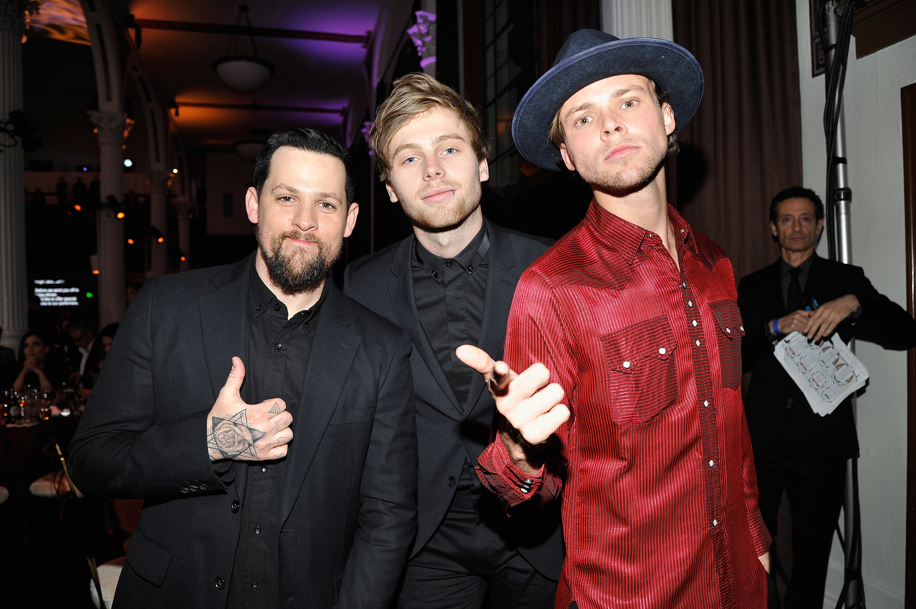 Luke and Michael Clifford posing with Joel Madden