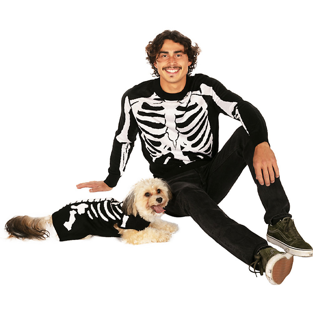 a small dog and a man in matching black sweaters with skeleton bones on them