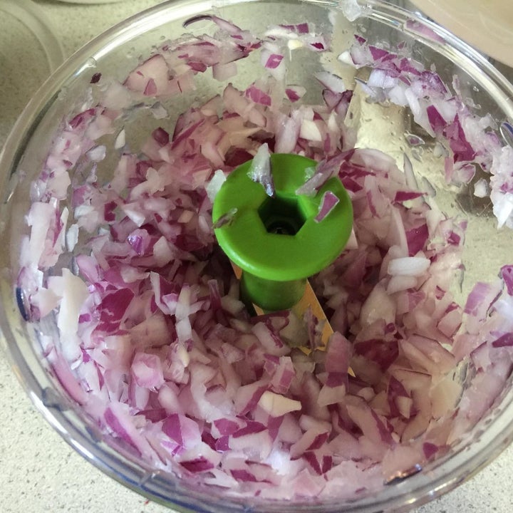 Reviewer veggie chopper with onions inside after being chopped