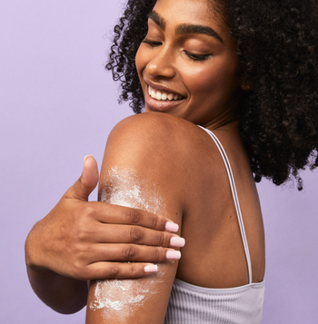 a model rubbing the exfoliator into their arm