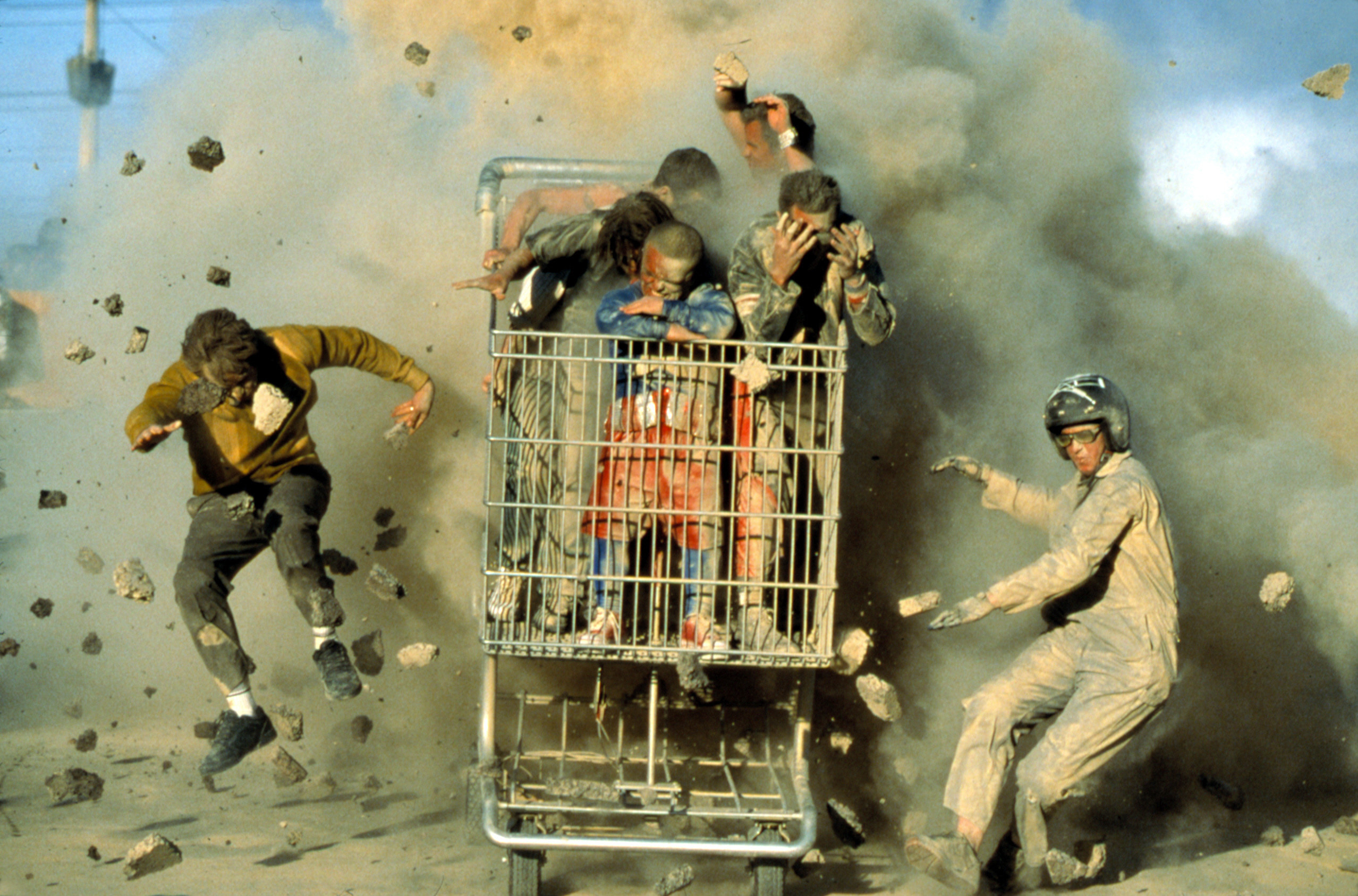 Cast of Jackass in a giant shopping cart in an explosion