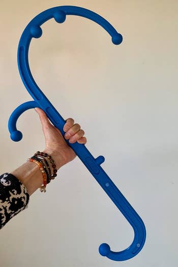 a reviewer photo of a hand holding the hooked cane 