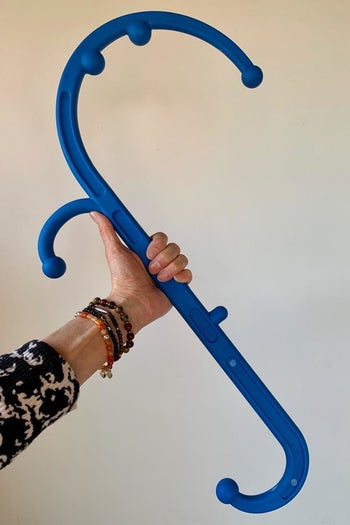 a reviewer photo of a hand holding the hooked cane