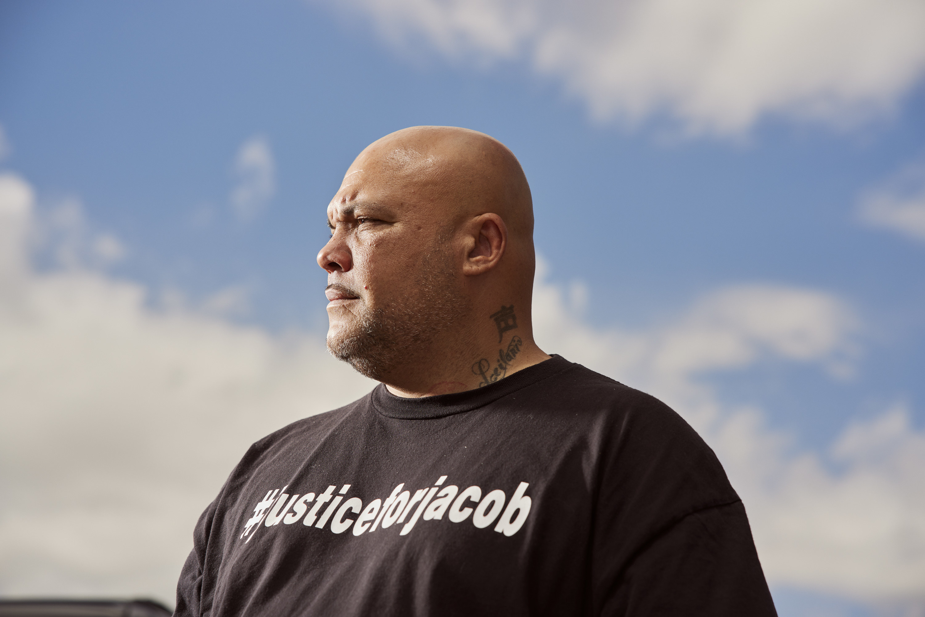 Roland Harris, photographed among the clouds, with a T-shirt that reads #justiceforjacob