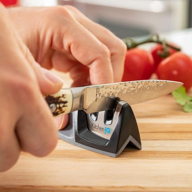 Person using a kitchenIQ small knife sharpener to sharpen knife
