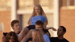 A gif from mean girls of the boys in gym class carrying Regina George