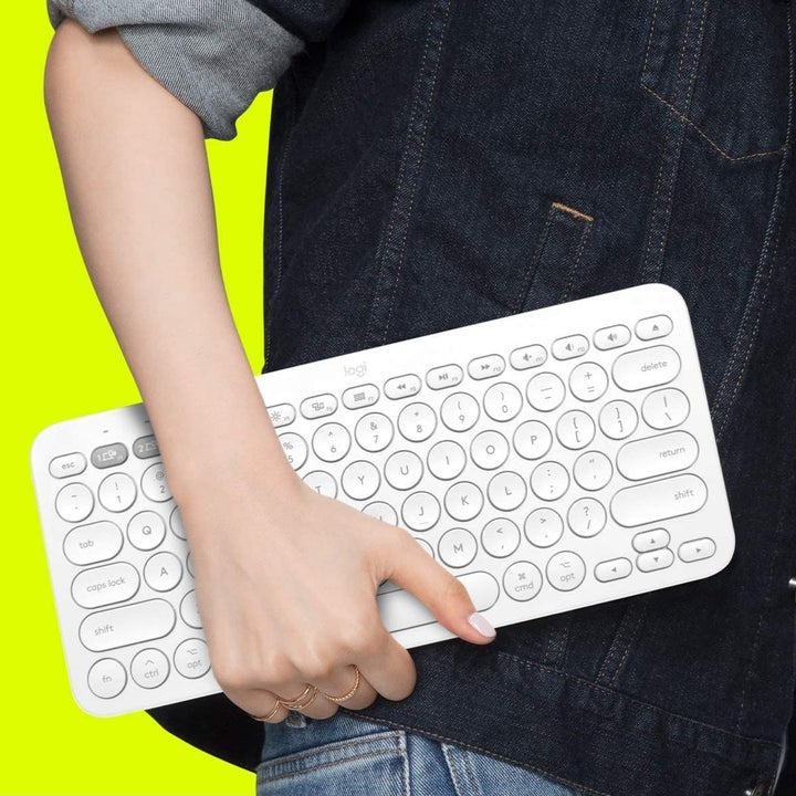 A person carrying the keyboard under one arm