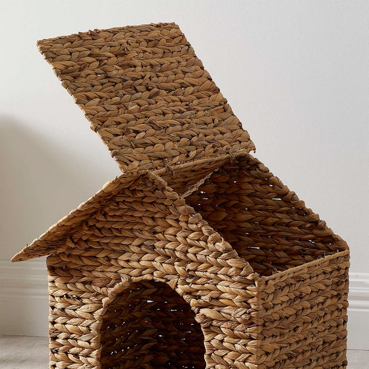 The pet bed with one of the roof flaps open