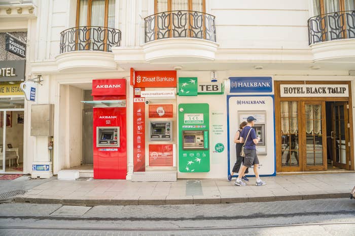 Different ATMs lined up next to one another.