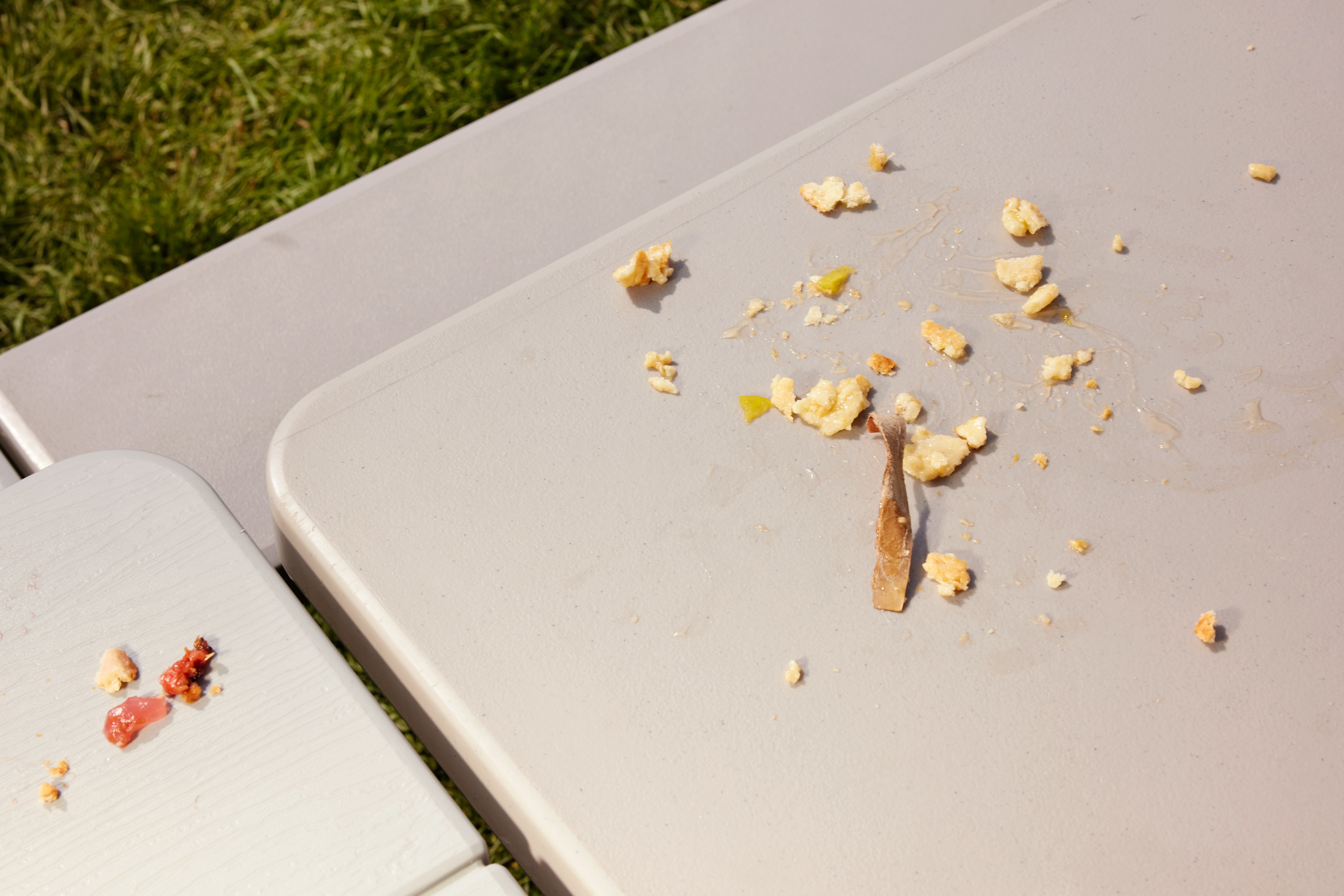 Pie crust and filling smeared on an outdoor picnic table after the contest