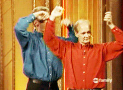 A gif of Ryan and Colin dancing with their arms over their heads