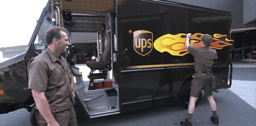 Conan O&#x27;Brien putting a giant flame decal on a UPS truck